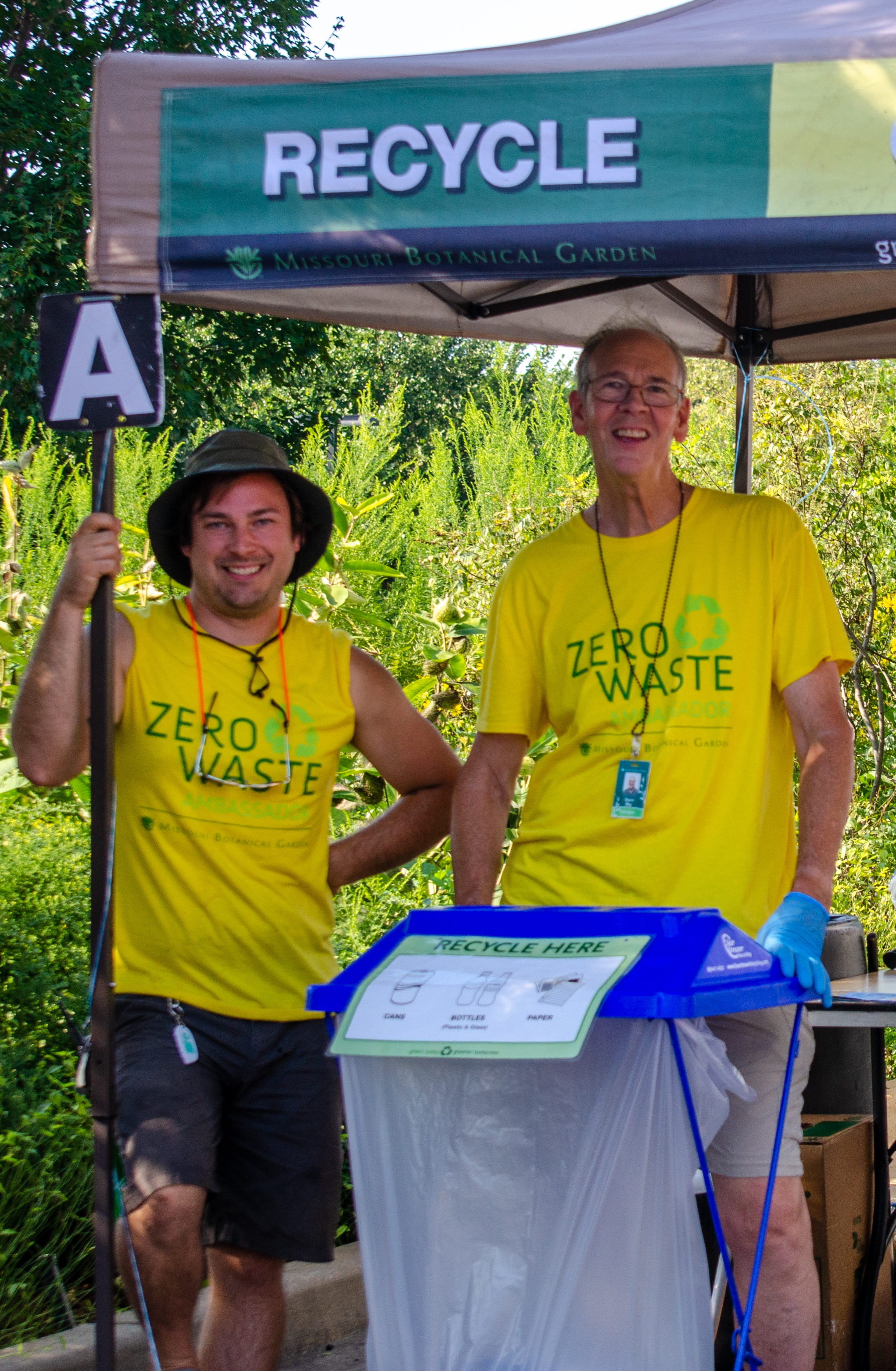 Volunteers in yellow "Zero Waste Ambassadors" await trash, compostables, and recyclables to sort at the Garden's Japanese Festival.